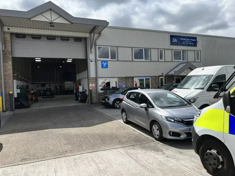 Hopfields Auto Repairs, Unit 3A Wilks Avenue, Dartford — the workshop door, the DVSA MOT sign and the customer entrance